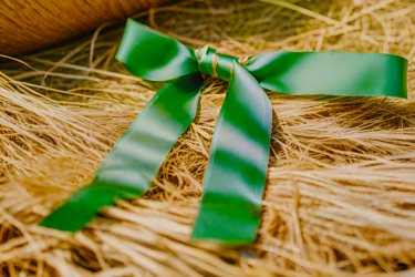 Realistic AI image showing green ribbon on a hay bale.